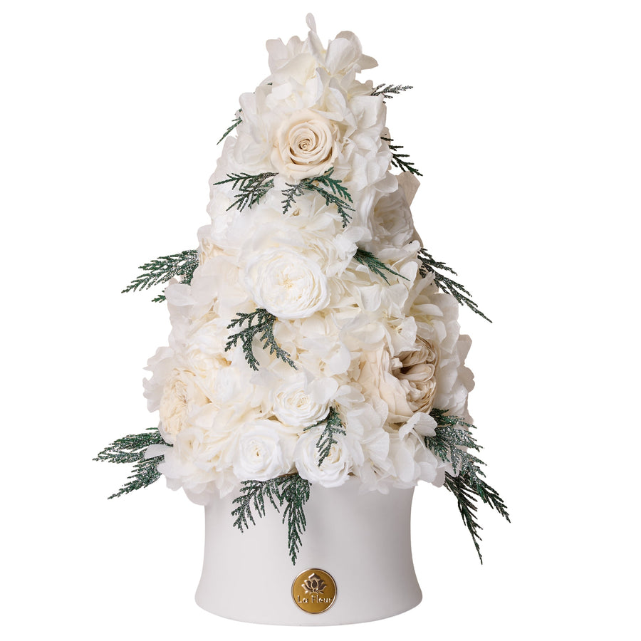 Floral arrangement in a white vase on a white background